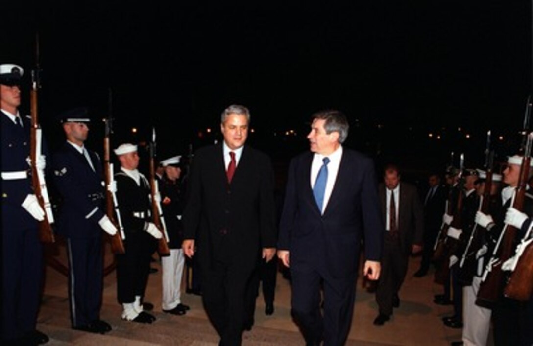 Prime Minister Adrian Nastase (left), of Romania, is escorted through an honor cordon and into the Pentagon by Deputy Secretary of Defense Paul Wolfowitz on Oct. 31, 2001. 