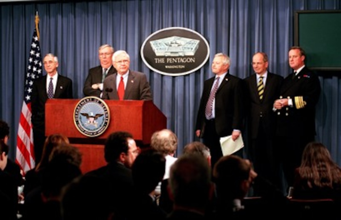 Under Secretary of Defense for Acquisition, Technology and Logistics Edward C. "Pete" Aldridge Jr. (center) announces the decision to proceed with the Joint Strike Fighter program at the Pentagon on Oct. 26, 2001, moving the program to the System Development and Demonstration phase. Reflecting the multi-service, multi-national interest in the plane, Aldridge was joined for the announcement by Secretary of the Navy Gordon England (far left), Secretary of the Air Force James G. Roche (2nd from left), United Kingdom's Minister of Defence for Procurement Lord Willy Bach, National Armaments Director and Chief of Defence Procurement Sir Robert Walmsley, and Vice Adm. Sir Jeremy Blackham, deputy chief of the Defence Staff (Equipment Capabilities). 