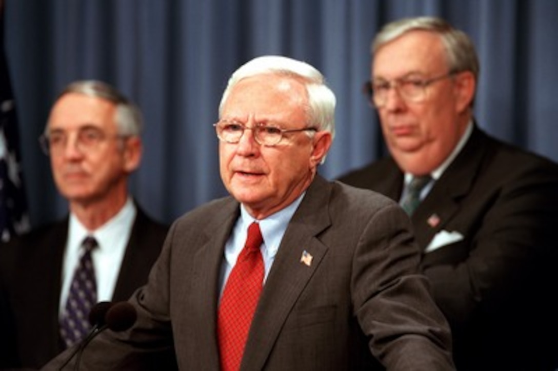 Under Secretary of Defense for Acquisition, Technology and Logistics Edward C. "Pete" Aldridge Jr. announces the decision to proceed with the Joint Strike Fighter program, at the Pentagon on Oct. 26, 2001, moving the program to the System Development and Demonstration phase. The Joint Strike Fighter is a multi-service, multi-nation, family of warplanes which will be produced in three versions to fit the requirements of the U.S. Air Force, Navy, and Marine Corps as well as the British Royal Air Force and Navy. The program is the largest acquisition program in the history of the Department of Defense. Secretary of the Navy Gordon England (left) and Secretary of the Air Force James Roche joined Aldridge for the announcement. 