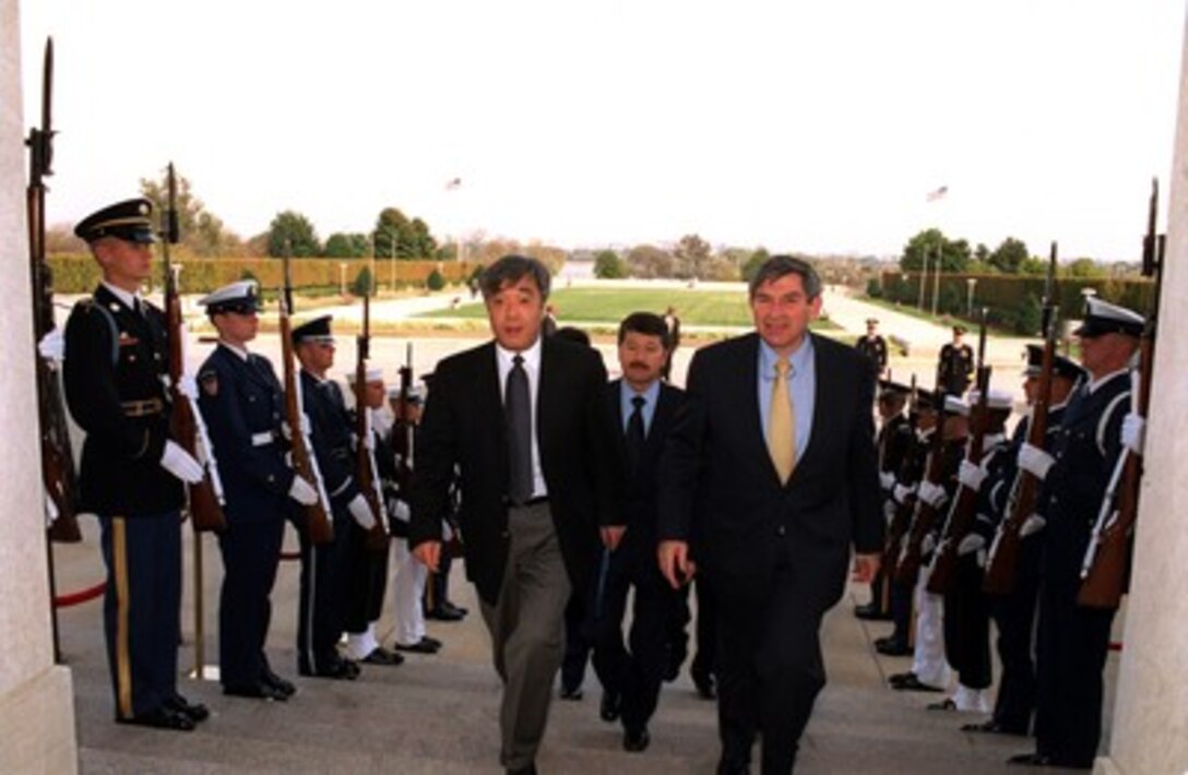 Deputy Secretary of Defense Paul Wolfowitz (right) escorts Minister of Foreign Affairs Yerlan Idrisov, of the Republic of Kazakhstan, through an honor cordon and into the Pentagon on Nov. 1, 2001. 