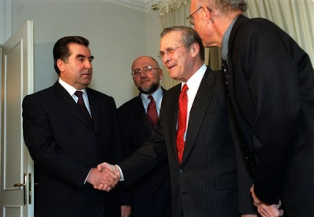 President Emomali Rahmonov (left), of Tajikistan, welcomes Secretary of Defense Donald H. Rumsfeld to the Presidential Palace in Dushanbe, Tajikistan, on Nov. 3, 2001. Rumsfeld is visiting the Tajik capitol to discuss the war on terrorism with Rahmonov. Also appearing in the photo is the interpreter Alexei Sobchenko (2nd from left), of the U.S. Department of State, and U.S. Ambassador to Tajikistan Franklin Huddle (right). 