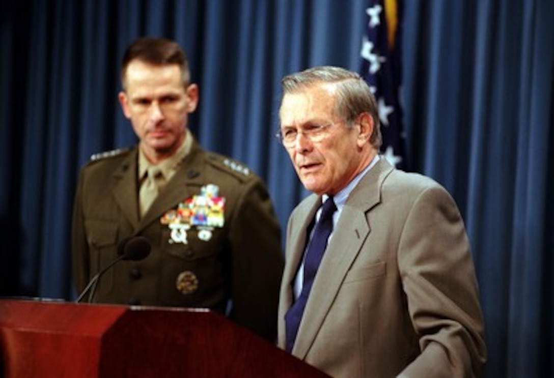 Secretary of Defense Donald H. Rumsfeld (right) and Vice Chairman of the Joint Chiefs of Staff Gen. Peter Pace provide reporters with an operational update on the missions in Afghanistan during a Pentagon press briefing on Nov. 6, 2001. 