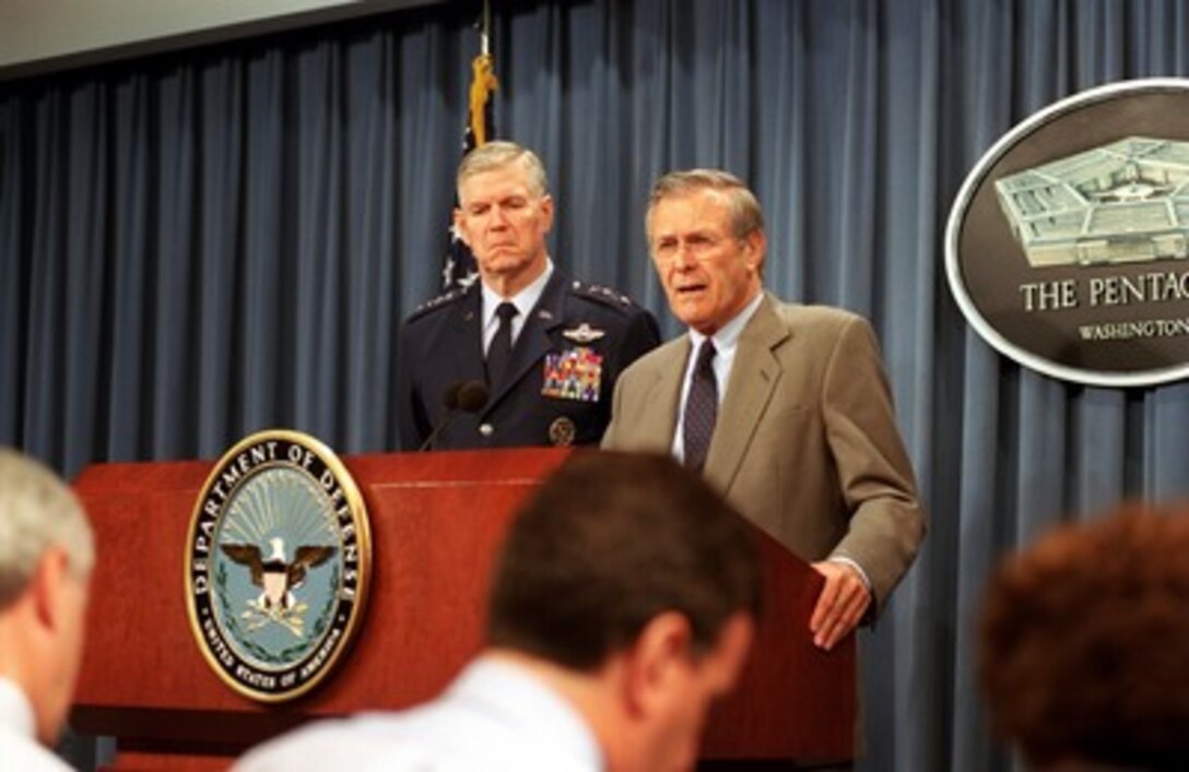 Secretary of Defense Donald H. Rumsfeld (right) responds to a reporter's question during a Pentagon news briefing with Chairman of the Joint Chiefs of Staff Gen. Richard B. Myers, U.S. Air Force, on Oct. 29, 2001. 