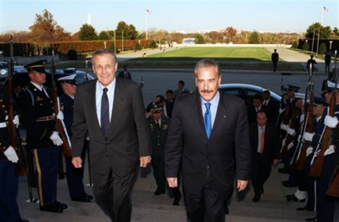 Secretary of Defense Donald H. Rumsfeld (left) escorts Colombian President Andres Pastrana through an honor cordon and into the Pentagon on Nov. 9, 2001. Pastrana will meet with Rumsfeld and Deputy Secretary of Defense Paul Wolfowitz to discuss a range of bilateral security issues of interest to both nations. 