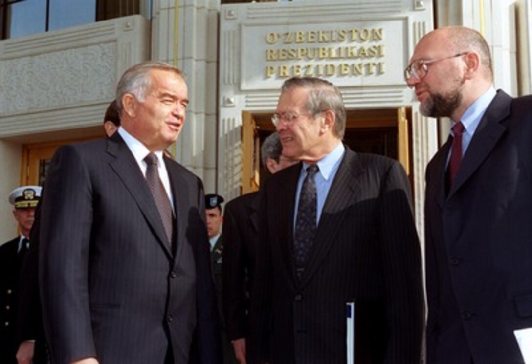 Secretary of Defense Donald H. Rumsfeld (center) talks informally with Uzbekistan President Islom Karimov (left) following their meeting in the Presidential Palace in the capitol city of Tashkent on Nov. 4, 2001. Rumsfeld and the Karimov discussed the developing bilateral relationship between the military agencies of the two nations. Standing at the right is Alexei Sobchenko, an interpreter with the Department of State. 