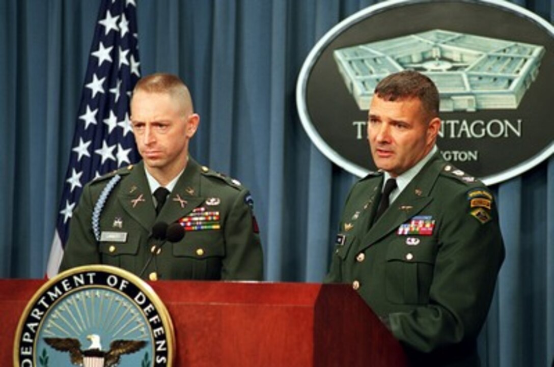 Army Col. Gary Varney (right) responds to a reporter's question during a Nov. 20, 2001, Pentagon press briefing on the cold weather training and capabilities of U.S. forces. Commandant of the Army National Guard Mountain Warfare School Lt. Col. Terry Lambert (left) joined Varney for the briefing. Varney is the deputy chief of staff for Operations, Vermont Army National Guard. 