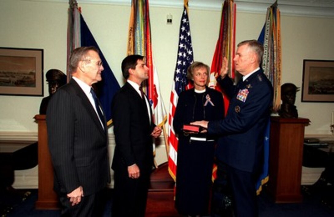 Gen. Richard B. Myers (right), U.S. Air Force, is sworn in as chairman of the Joint Chiefs of Staff by William Haynes (2nd from left), as Myer's wife Mary Jo Myers holds the Bible, in the Pentagon office of Secretary of Defense Donald H. Rumsfeld (left) on Oct. 1, 2001. Myers is the 15th chairman of the Joint Chiefs of Staff. Haynes is the General Counsel of the Department of Defense. 