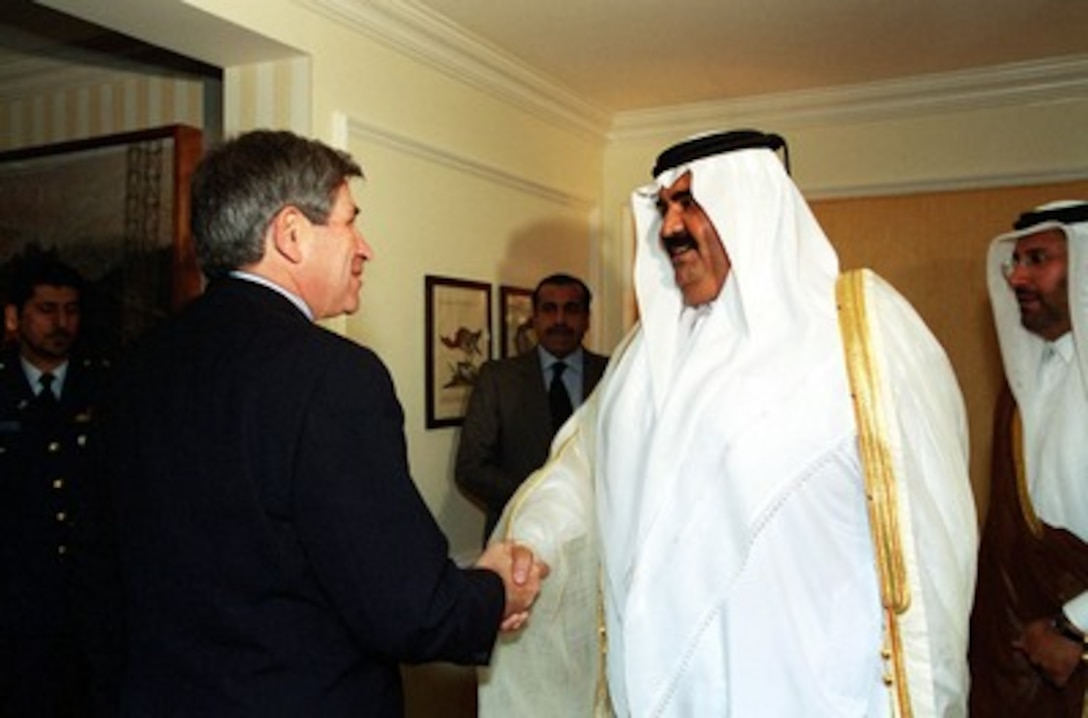 Deputy Secretary of Defense Paul Wolfowitz (left) meets with Amir Shaikh Hamad bin Khalifa Al-Thani, of Qatar in Washington on Oct. 5, 2001. The Amir presented a $1 million check to Wolfowitz to be used to assist families of victims of the September 11 terrorist attack on the Pentagon. 