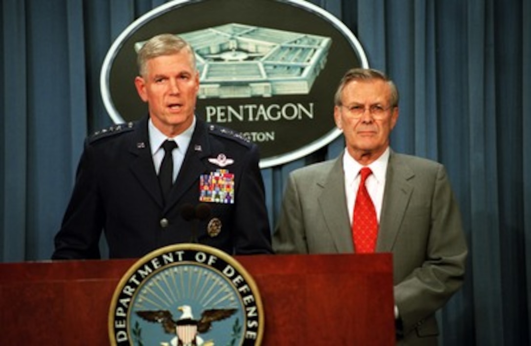 Chairman of the Joint Chiefs of Staff Gen. Richard B. Myers (left), U.S. Air Force, responds to a reporter's question during a Pentagon press briefing on Oct. 7, 2001, concerning the military strikes against al Qaeda terrorist training camps and military installations. Secretary of Defense Donald H. Rumsfeld announced the strikes, which are carefully targeted actions designed to disrupt the use of Afghanistan as a base for terrorist operations and to attack the military capability of the Taliban regime. 