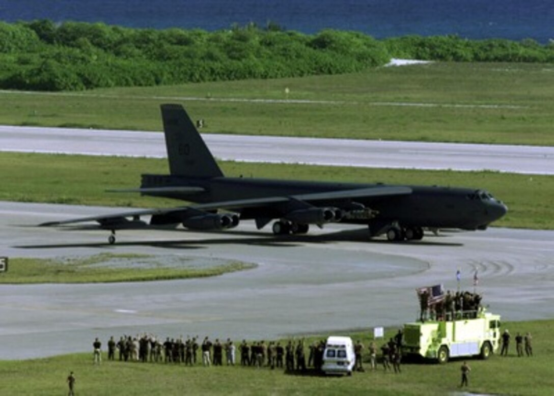 Ground crew members wave at a B-52H Stratofortress bomber as it taxis for take off on a strike mission against al Qaeda terrorist training camps and military installations of the Taliban regime in Afghanistan on Oct. 7, 2001, during Operation Enduring Freedom. The carefully targeted actions are designed to disrupt the use of Afghanistan as a base for terrorist operations and to attack the military capability of the Taliban regime. 