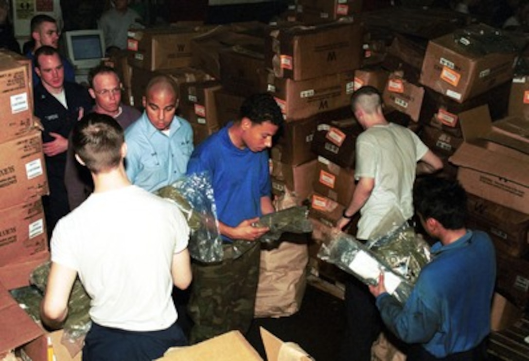 Crew men of the USS Enterprise (CVN 65) line up to receive an Advanced Chemical Protective Garments issued for protection against chemical, biological, or radiological attack on Oct. 7, 2001, during Operation Enduring Freedom. 