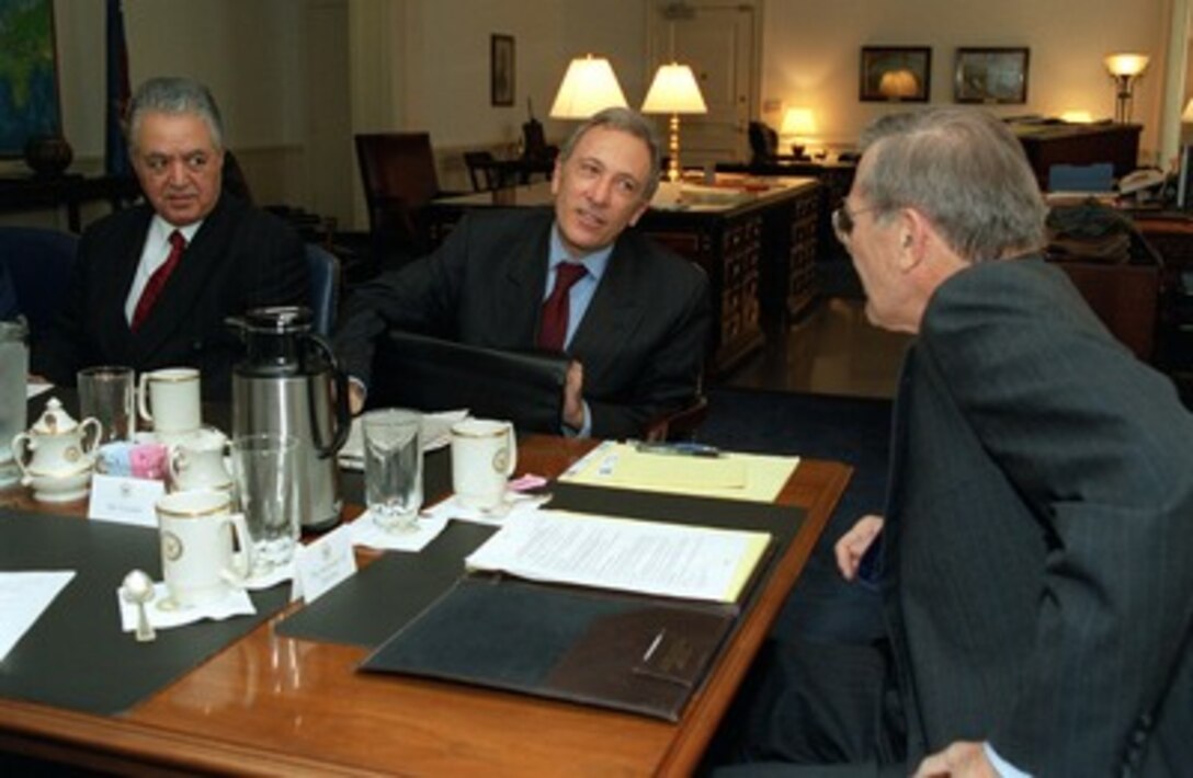 Secretary of Defense Donald H. Rumsfeld (right) meets in his Pentagon office with Turkish Foreign Minister Ismail Cem (center) on Sept. 27, 2001. Turkish Ambassador to the U.S. Baki Ilkin (left) joined Rumsfeld and Cem in discussions about the war on terrorism. 