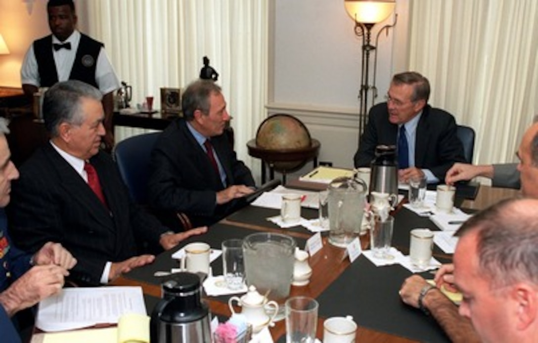 Secretary of Defense Donald H. Rumsfeld (right) meets in his Pentagon office with Turkish Foreign Minister Ismail Cem (center) on Sept. 27, 2001. Turkish Ambassador to the U.S. Baki Ilkin (left) and senior policy officials of the Department of Defense joined Rumsfeld and Cem in discussions about the war on terrorism. 