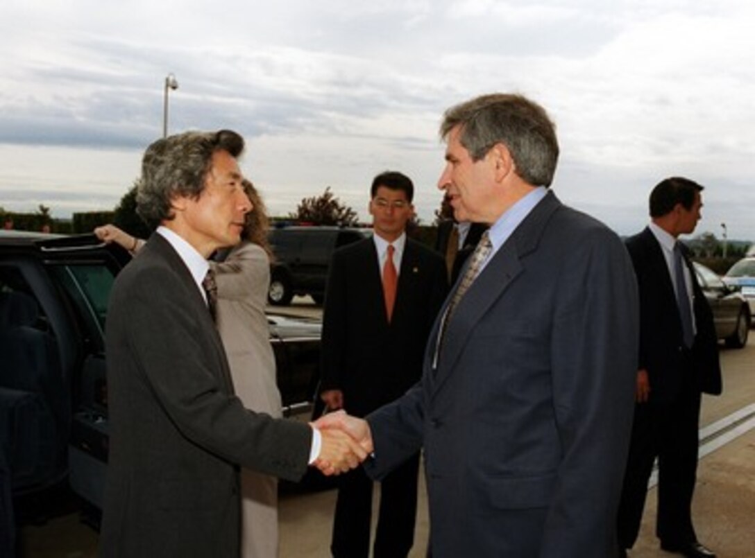 Deputy Secretary of Defense Paul Wolfowitz (right) greets Japan's Prime Minister Junichiro Koizumi (left) at the Pentagon on Sept. 25, 2001. 
