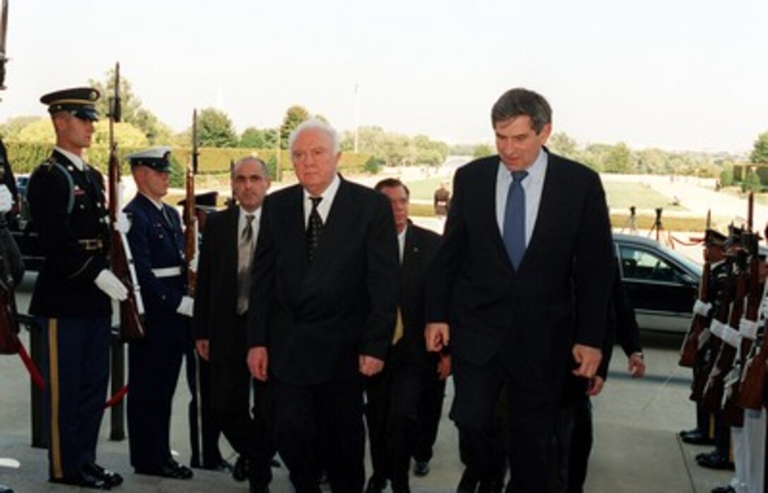 Georgian President Eduard Shevardnadze (left) is escorted through an honor cordon and into the Pentagon by Deputy Secretary of Defense Paul Wolfowitz (right) on Oct. 5, 2001. 