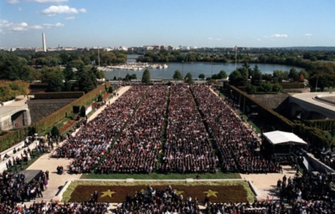 An audience of approximately 15,000 people fills the parking lot, parade field and lower parade field at the Pentagon River entrance on Oct. 11, 2001, for the Pentagon memorial service in honor of those who perished in the terrorist attack on the building. President George W. Bush, Secretary of Defense Donald H. Rumsfeld and Chairman of the Joint Chiefs of Staff Gen. Richard B. Myers, U.S. Air Force, eulogized the 184 persons killed when a terrorist hijacked airliner was purposely crashed into the southwest face of the building on Sept. 11, 2001. 