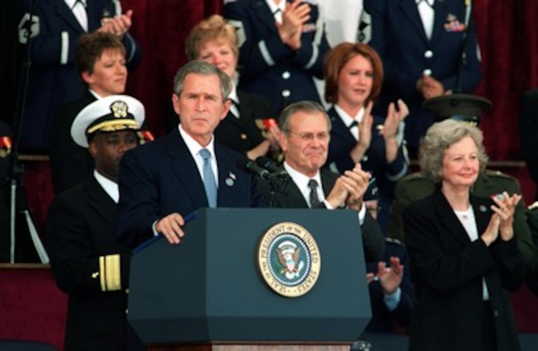 President George W. Bush gets a standing ovation during his address at the Pentagon memorial service on Oct. 11, 2001, in honor of those who perished in the terrorist attack on the building. Bush, Secretary of Defense Donald H. Rumsfeld and Chairman of the Joint Chiefs of Staff Gen. Richard B. Myers, U.S. Air Force, eulogized the 184 persons killed when a terrorist hijacked airliner was purposely crashed into the southwest face of the building on Sept. 11, 2001. 