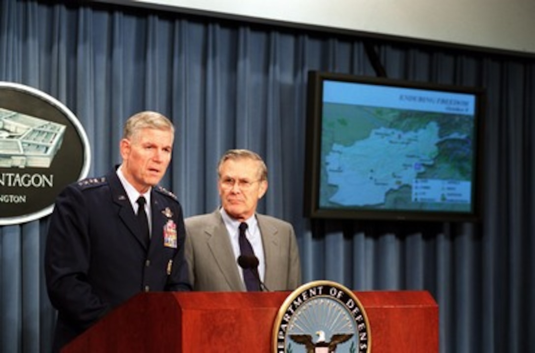 Chairman of the Joint Chiefs of Staff Gen. Richard B. Myers, U.S. Air Force, briefs reporters, as Secretary of Defense Donald H. Rumsfeld listens, during a Pentagon press briefing on Oct. 9, 2001. Myers and Rumsfeld reported on the bombing of targets in Afghanistan and the progress of Operation Enduring Freedom. 