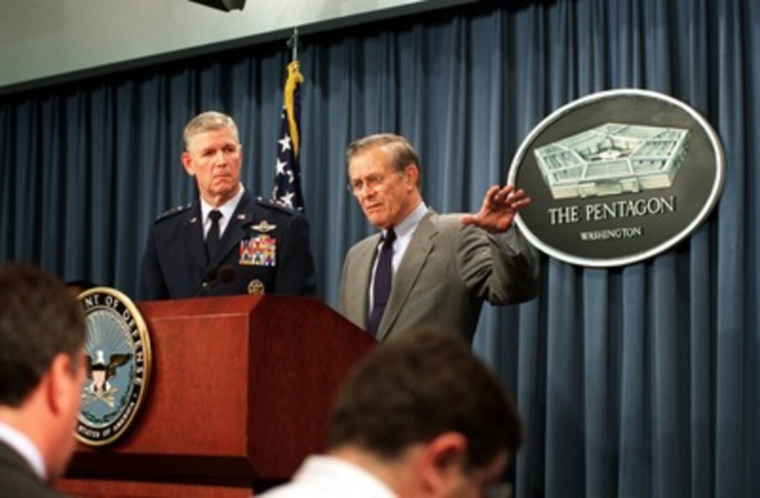 Secretary of Defense Donald H. Rumsfeld responds to a reporter's question during a Pentagon press briefing with Chairman of the Joint Chiefs of Staff Gen. Richard B. Myers, U.S. Air Force, on Oct. 9, 2001. Rumsfeld and Myers reported on the bombing of targets in Afghanistan and the progress of Operation Enduring Freedom. 