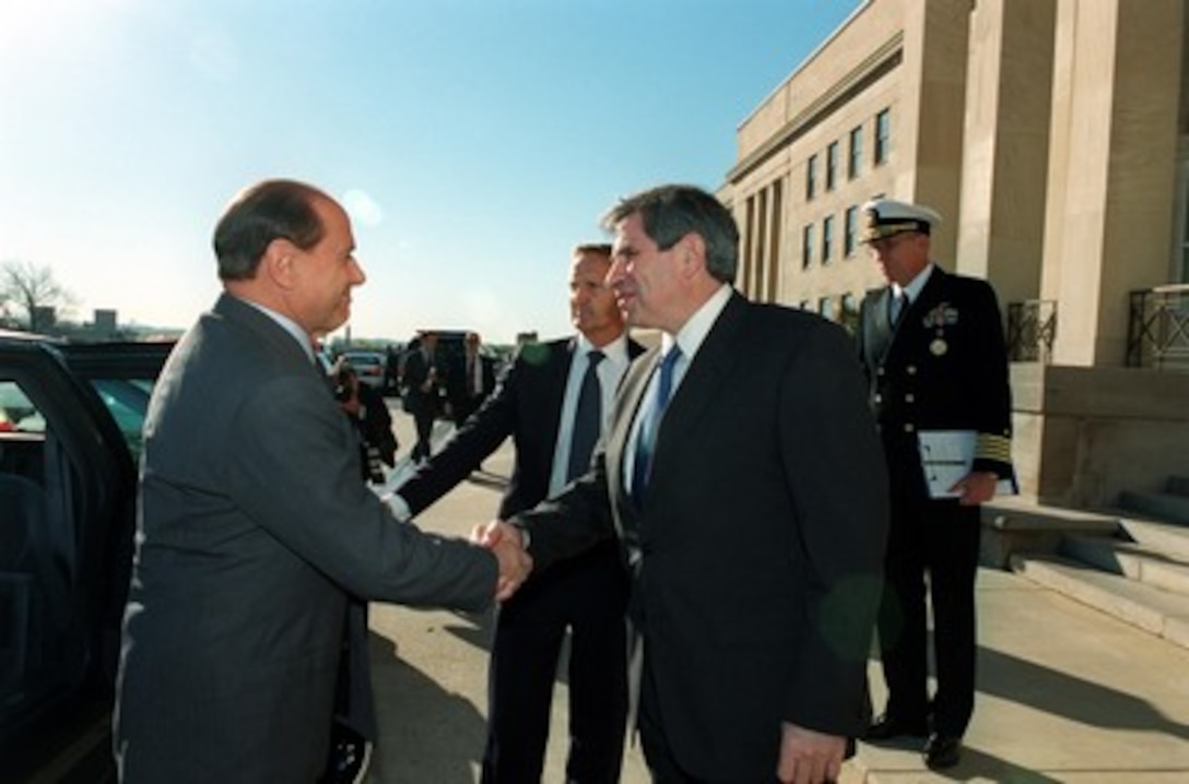 Italian Prime Minister Silvio Berlusconi (left) is greeted at the Pentagon by Deputy Secretary of Defense Paul Wolfowitz (right) on Oct. 15, 2001. 
