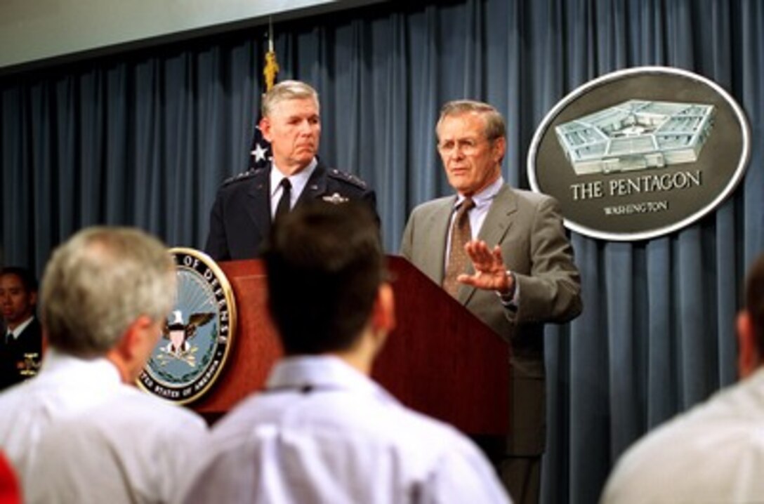 Secretary of Defense Donald H. Rumsfeld (right) and Chairman of the Joint Chiefs of Staff Gen. Richard B. Myers, U.S. Air Force, brief reporters at the Pentagon on Operation Enduring Freedom on Oct. 12, 2001. Rumsfeld and Myers brought reporters up to date on the progress of the on-going air campaign being directed against the al Qaeda terrorist organization and the military capability of Taliban regime in Afghanistan. 