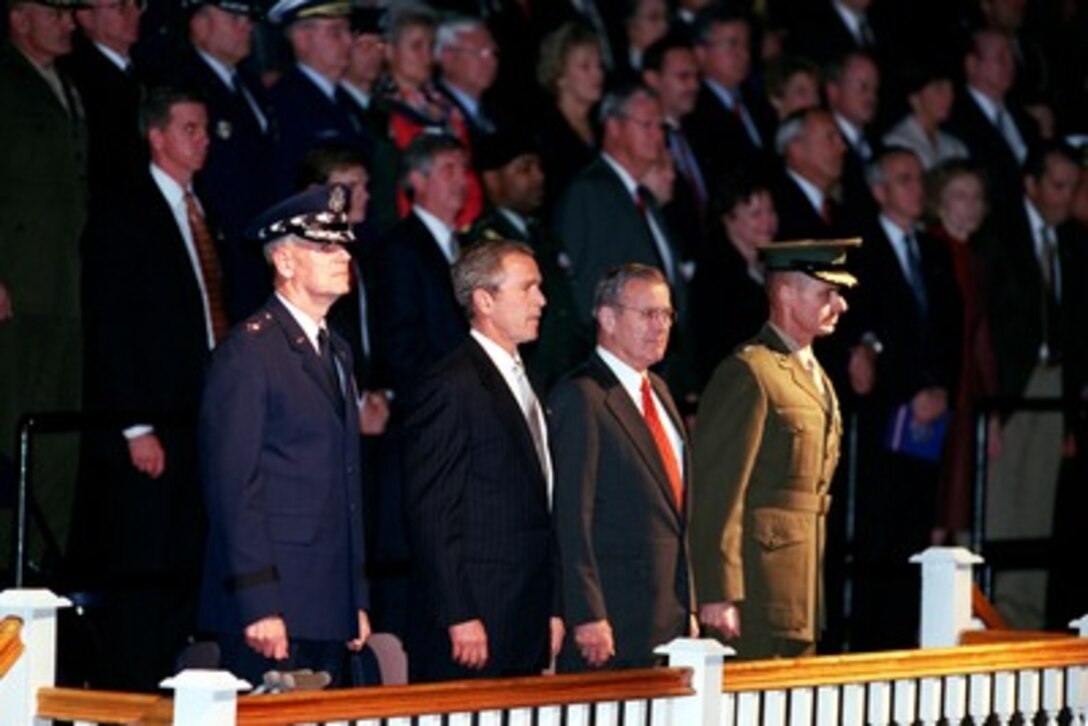 Chairman of the Joint Chiefs of Staff Gen. Richard B. Myers, U.S. Air Force, President George W. Bush, Secretary of Defense Donald H. Rumsfeld, and Vice Chairman of the Joint Chiefs of Staff Gen. Peter Pace, U.S. Marine Corps, watch troops pass in review at Fort Myer, Va., on Oct. 15, 2001. The pass in review concluded a welcoming ceremony for the new chairman and vice chairman who were officially sworn in on Oct. 1, 1001. 
