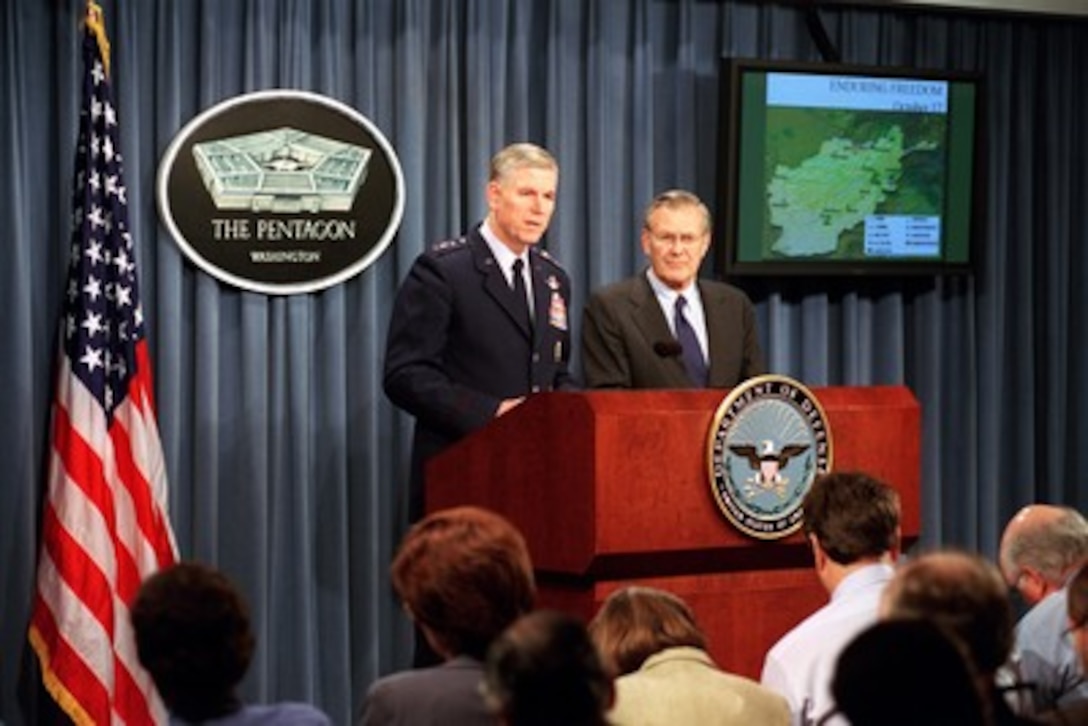 Chairman of the Joint Chiefs of Staff Gen. Richard B. Myers (left), U.S. Air Force, comments on the military operations conducted by U.S. air assets over Afghanistan on the previous day during an Oct. 18, 2001, Pentagon press briefing. Secretary of Defense Donald H. Rumsfeld (right) joined Myers at the brief. 