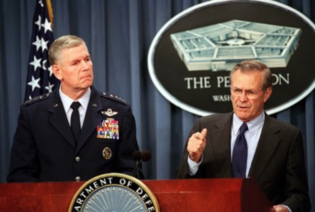 Secretary of Defense Donald H. Rumsfeld (right) explains to reporters that there is no single coalition of nations in this war on terrorism during a press briefing at the Pentagon on Oct. 18, 2001, Chairman of the Joint Chiefs of Staff Gen. Richard B. Myers (left), U.S. Air Force, briefed reporters on some of the previous day's operational details. 
