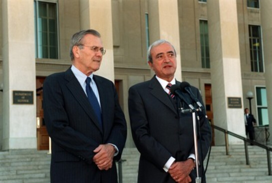 Italian Minister of Defense Antonio Martino (right) answers a reporter's question during a media availability with Secretary of Defense Donald H. Rumsfeld (left) outside the Pentagon on Oct. 18, 2001. Martino and Rumsfeld met earlier to discuss the war on terrorism including the current military operations underway in Afghanistan. 