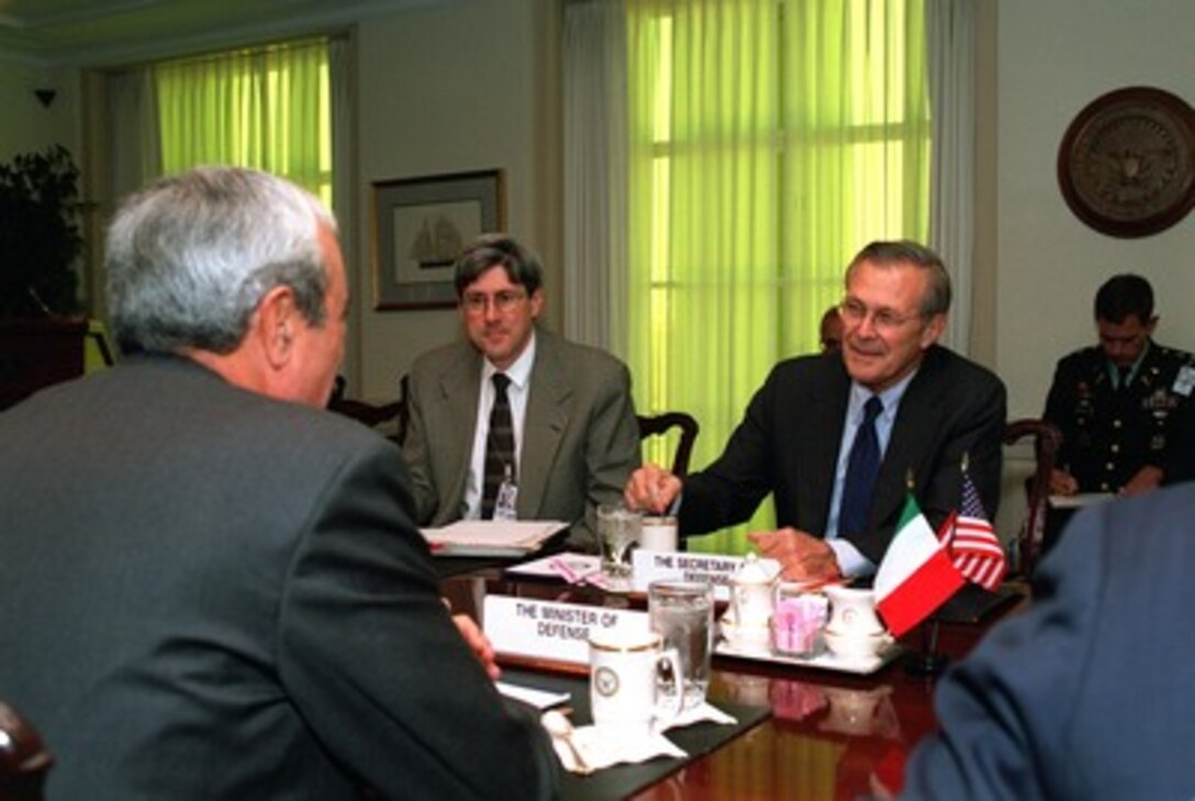 Secretary of Defense Donald H. Rumsfeld (right) meets with Italian Minister of Defense Antonio Martino (left) in the Pentagon on Oct. 18, 2001. Rumsfeld and Martino are discussing the war on terrorism including the current military operations underway in Afghanistan. Under Secretary of Defense for Policy Douglas Feith (center) joined Rumsfeld and Martino in the talks. 