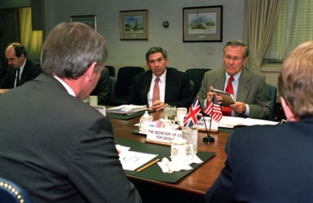 Secretary of Defense Donald Rumsfeld (right, facing) meets with British Secretary of State for Defence Geoffrey Hoon (left, near-side) in the Pentagon on Oct. 30, 2001. Rumsfeld and Hoon and meeting to discuss the progress of the war against terrorism including the present military campaign against Taliban and al Qaeda forces in Afghanistan. Among those participating in the talks were Deputy Secretary of Defense Paul Wolfowitz (left of Rumsfeld) and Ambassador Christopher Meyer (right), the British ambassador to the U.S. 