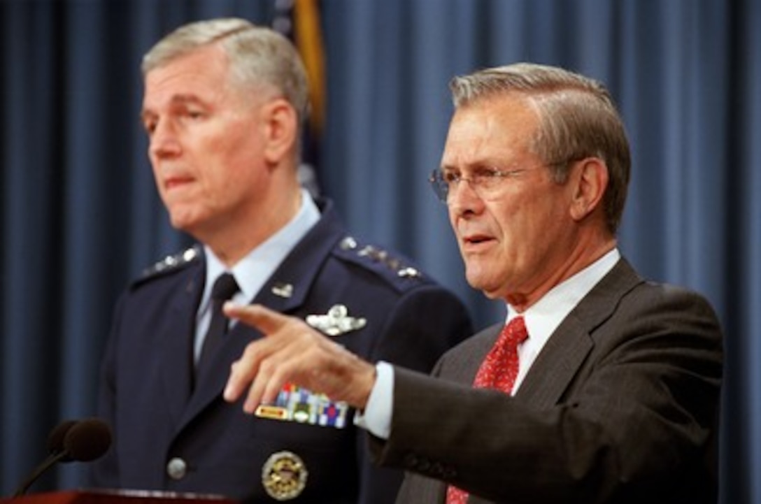 Secretary of Defense Donald H. Rumsfeld (right) and Chairman of the Joint Chiefs of Staff Gen. Richard B. Myers (left), U.S. Air Force, conduct an operational update briefing on Operation Enduring Freedom in the Pentagon on Oct. 22, 2001. 