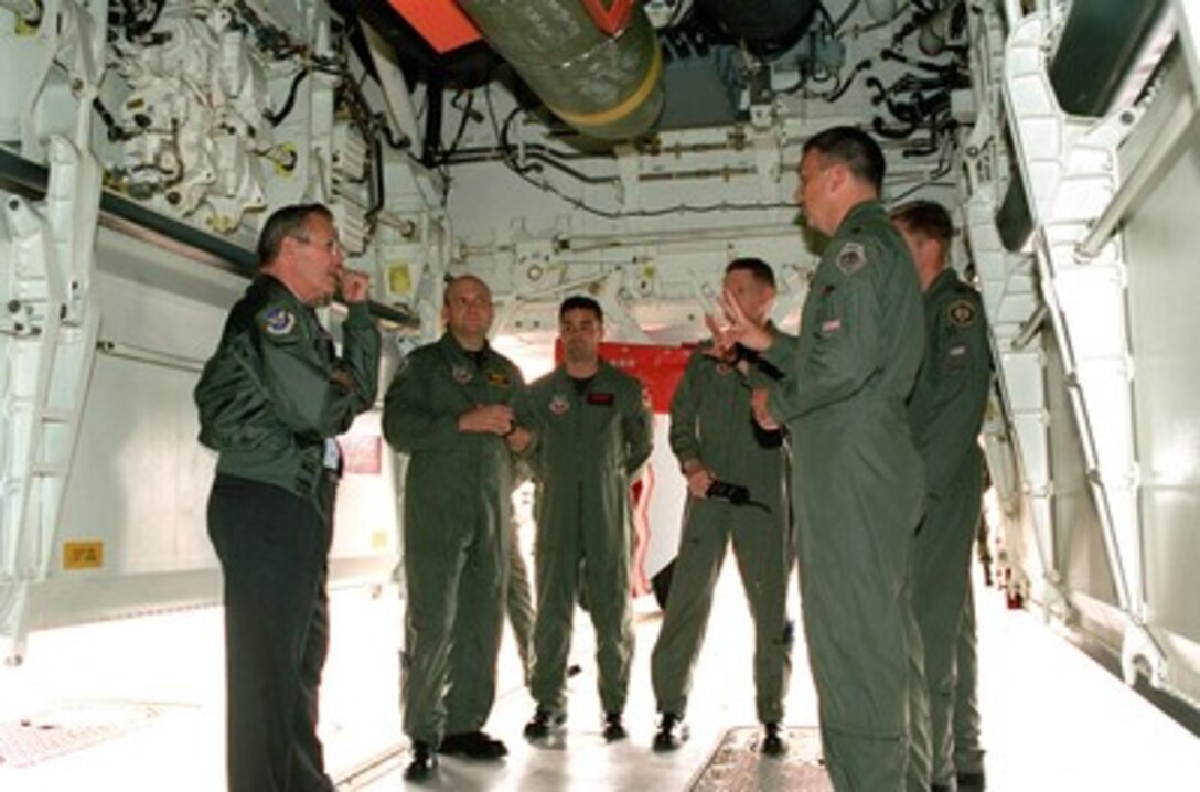 Secretary of Defense Donald H. Rumsfeld (left) stands under the open bomb bay of a U.S. Air Force B-2 Spirit bomber at Whiteman Air Force Base, Mo., on Oct. 19, 2001. Rumsfeld is talking to a group of B-2 pilots and mission commanders from the 509th Bomb Wing about the missions over Afghanistan during Operation Enduring Freedom. 
