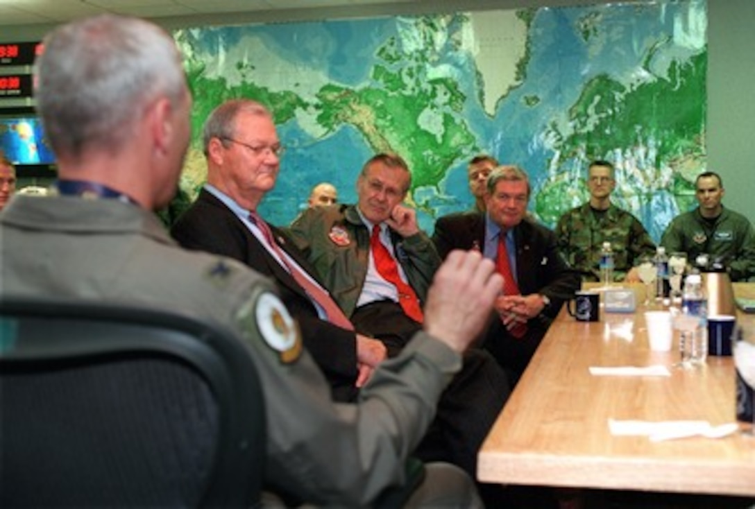 Secretary of Defense Donald H. Rumsfeld (3rd from left) receives a briefing on B-2 Spirit bomber operations in Afghanistan from Air Force Col. Jonathan George (left foreground) during a visit to Whiteman Air Force Base, Mo., on Oct. 19, 2001. Flanking Rumsfeld are Rep. Ike Skelton (near side) and Sen. Christopher "Kit" Bond (far side), both of Missouri. Whiteman is the home of the B-2 Spirit bomber, which is operated exclusively by the 509th Bomb Wing. Planes from the 509th have flown missions over Afghanistan during Operation Enduring Freedom. 