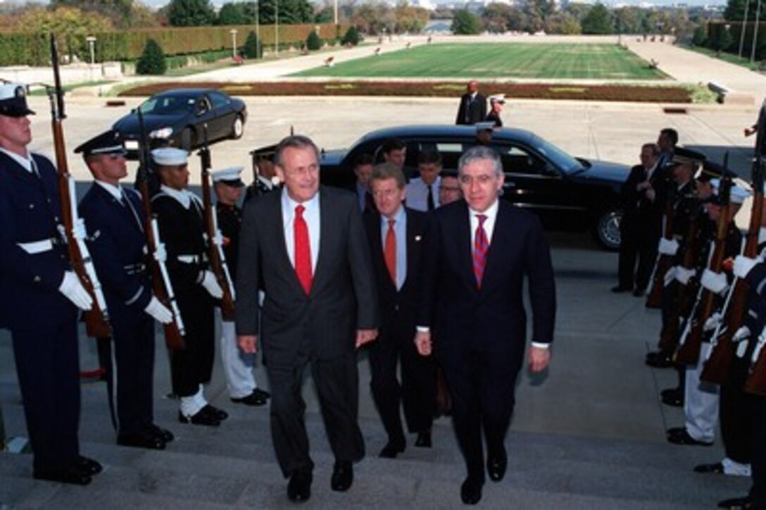 Secretary of Defense Donald H. Rumsfeld (left) escorts Secretary of State for Foreign and Commonwealth Affairs Jack Straw (right), of the United Kingdom, into the Pentagon on Oct. 24, 2001. Rumsfeld and Deputy Secretary of Defense Paul Wolfowitz will meet with Straw to discuss issues related to the war on terrorism and the ongoing military operations directed against the Taliban and al Qaeda terrorist organizations in Afghanistan. 