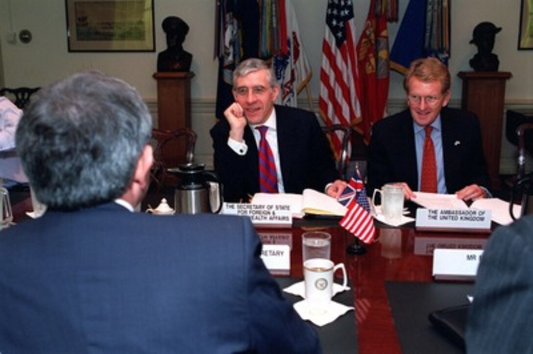 Secretary of State for Foreign and Commonwealth Affairs Jack Straw (center), of the United Kingdom, meets at the Pentagon with Deputy Secretary of Defense Paul Wolfowitz (left) on Oct. 24, 2001. Straw met earlier with Secretary of Defense Donald H. Rumsfeld to discuss issues related to the war on terrorism and the ongoing military operations directed against the Taliban and al Qaeda terrorist organizations in Afghanistan. United Kingdom's Ambassador to the U.S. Christopher Meyer (right) joined Straw and Wolfowitz in the discussion. 