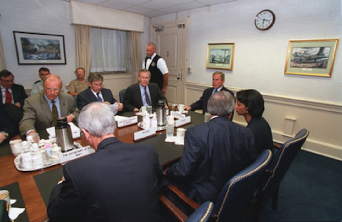 President Bush meets with Secretary of Defense Donald H. Rumsfeld and his staff at the Pentagon on Sept. 12, 2001. From left to right is Secretary of the Army Thomas E. White, Deputy Secretary of Defense Paul Wolfowitz, Rumsfeld, Bush, and National Security Advisor Condoleeza Rice. Bush inspected the site of the terrorist attack on the building to thank the men and women who assisted in containing the fires and rescuing victims. 