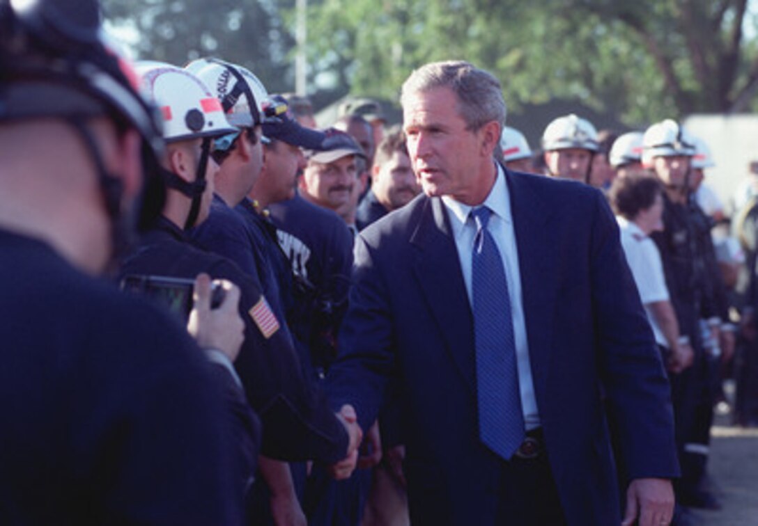 President George W. Bush thanks search and rescue personnel at the Pentagon during a visit on Sept. 12, 2001. Bush, accompanied by Secretary of Defense Donald H. Rumsfeld, National Security Advisor Condoleezza Rice, and Chief of Staff Andrew Card, toured the scene of destruction where a hijacked American Airlines flight was purposely crashed into the west side of the Pentagon. 