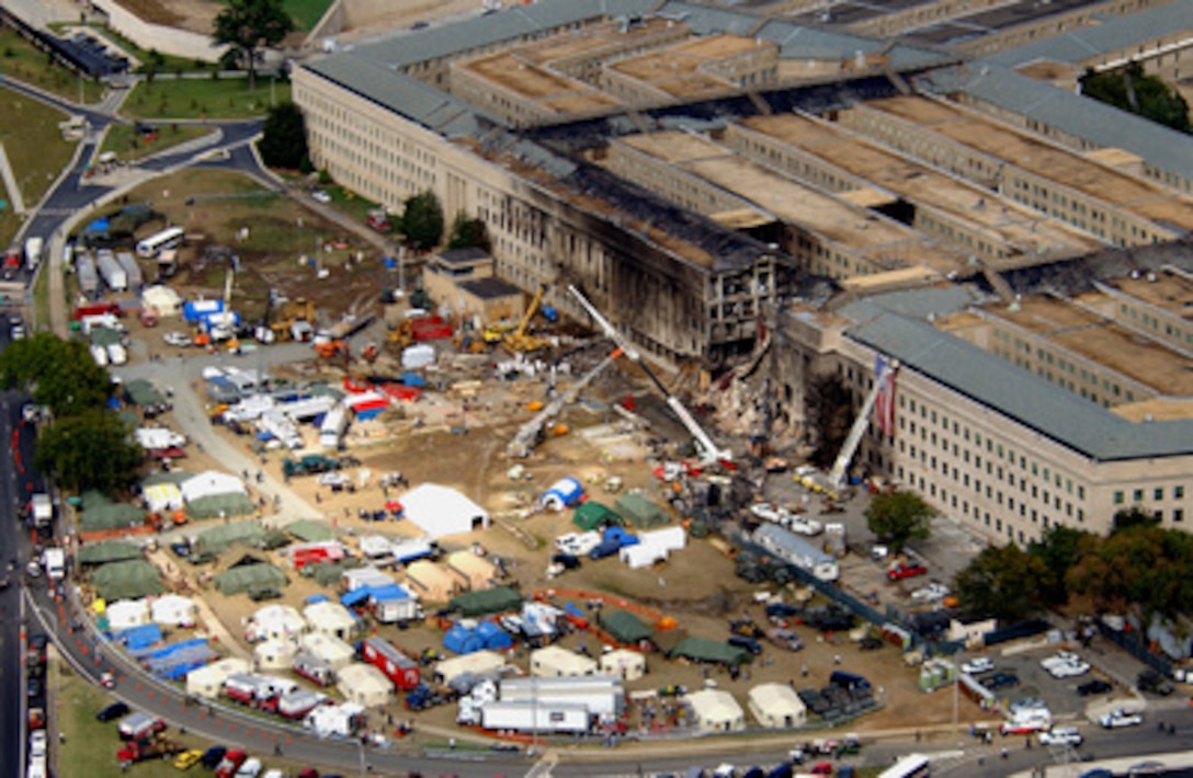 FBI agents, fire fighters, rescue workers and engineers work at the Pentagon crash site on Sept. 14, 2001, where a hijacked American Airlines flight slammed into the building on Sept. 11. The terrorist attack caused extensive damage to the west face of the building and followed similar attacks on the twin towers of the World Trade Center in New York City. 