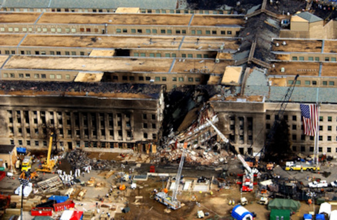 FBI agents, fire fighters, rescue workers and engineers work at the Pentagon crash site on Sept. 14, 2001, where a hijacked American Airlines flight slammed into the building on Sept. 11. The terrorist attack caused extensive damage to the west face of the building and followed similar attacks on the twin towers of the World Trade Center in New York City. 