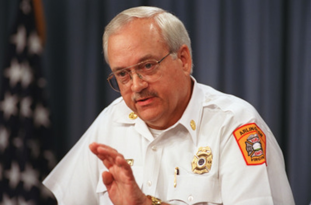 Arlington County, Va., Fire Chief Ed Plaugher briefs reporters in the Pentagon on the fire suppression efforts at the Pentagon on Sept. 12, 2001. The terrorist attack caused extensive damage to the west face of the building and followed similar attacks on the twin towers of the World Trade Center in New York City. 