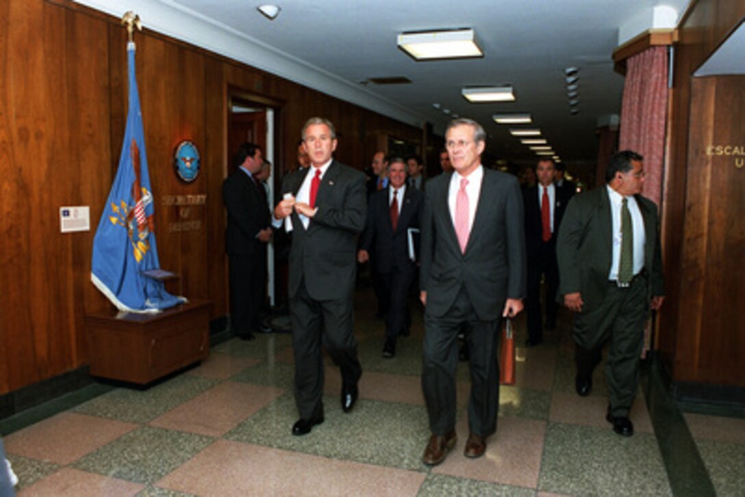 President George W. Bush (left) and Secretary of Defense Donald H. Rumsfeld walk to a meeting in the Pentagon on Sept. 17, 2001. Bush and Vice President Dick Cheney met with Rumsfeld and other members of the national security team at the Pentagon. 