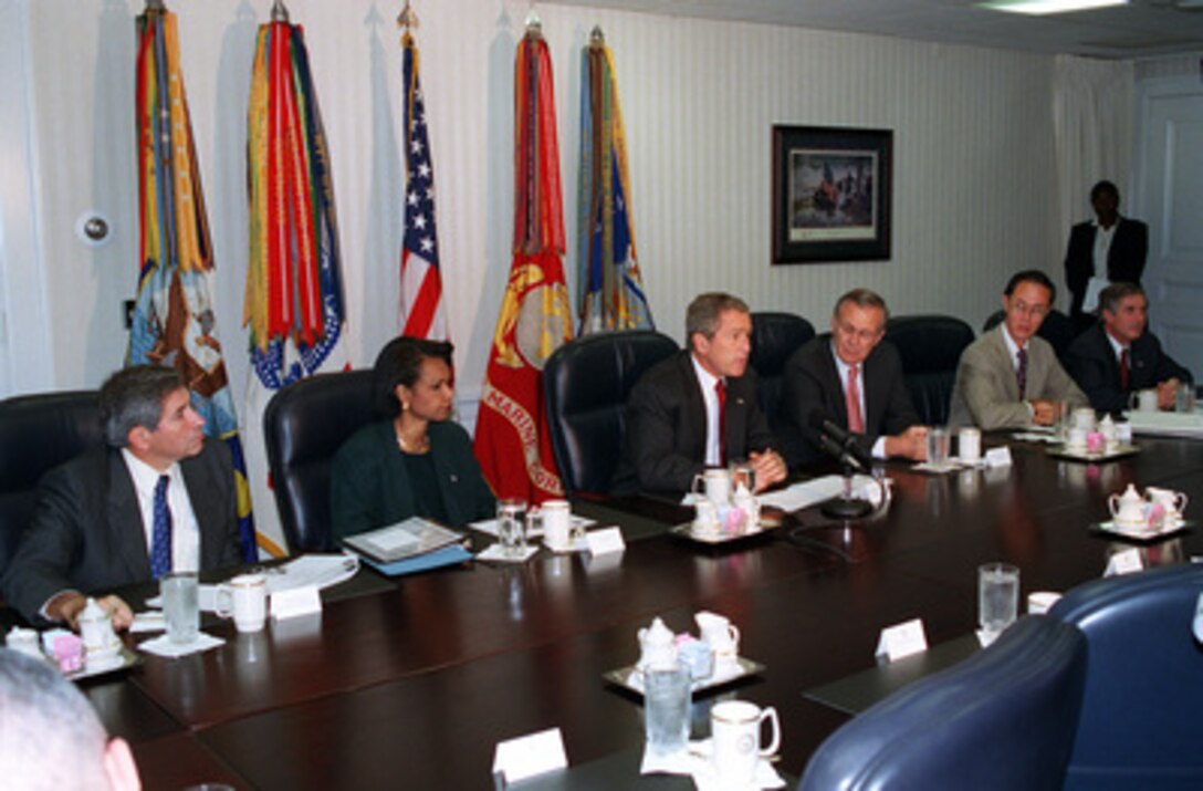 President George W. Bush addresses the media at the Pentagon on Sept. 17, 2001, following a meeting with his national security team and leaders of the National Guard and Reserve forces. From left are Deputy Secretary of Defense Paul Wolfowitz, National Security Advisor Condoleezza Rice, Bush, Secretary of Defense Donald H. Rumsfeld, Under Secretary of Defense for Personnel and Readiness David Chu, and White House Chief of Staff Andrew Card. 