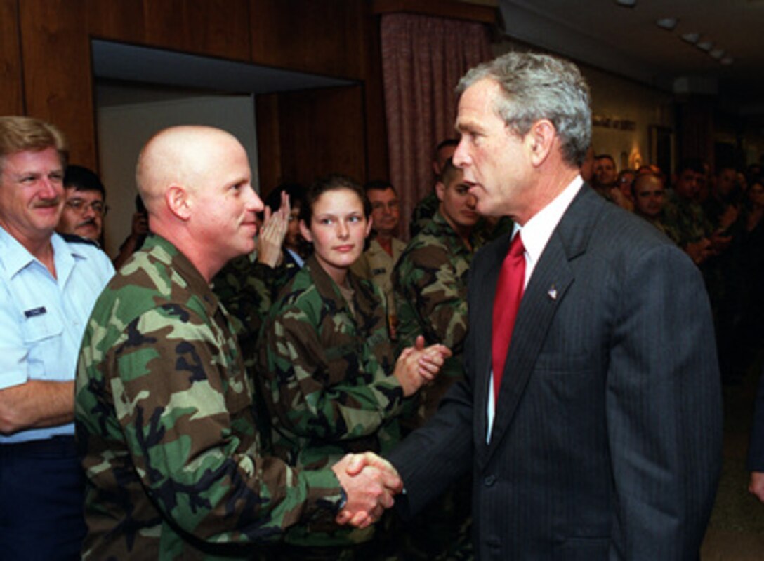 President George W. Bush shakes hands with an Army Reservist at the Pentagon on Sept. 17, 2001. Bush and Vice President Dick Cheney met earlier with Secretary of Defense Donald H. Rumsfeld and other members of the national security team at the Pentagon. Bush later informally greeted and thanked Pentagon personnel in the hallways and cafeteria. 