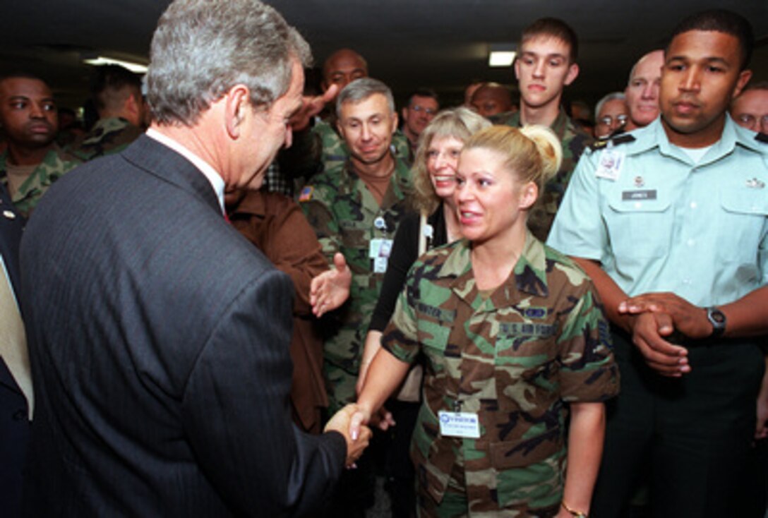 President George W. Bush shakes hands with Air Force Staff Sgt. Amy Hunter at the Pentagon on Sept. 17, 2001. Bush and Vice President Dick Cheney met earlier with Secretary of Defense Donald H. Rumsfeld and other members of the national security team at the Pentagon. Bush later informally greeted and thanked Pentagon personnel in the hallways and cafeteria. 