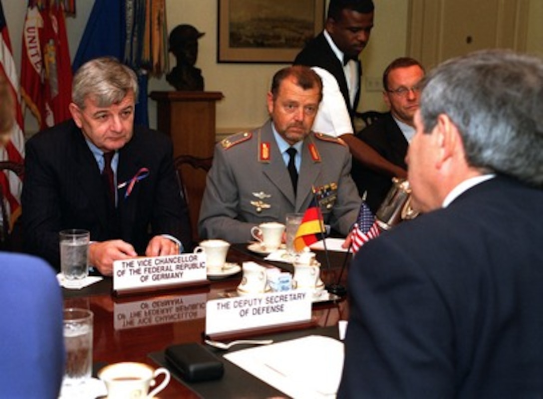 Foreign Minister Joschka Fischer (left) meets with Deputy Secretary of Defense Paul Wolfowitz (right) at the Pentagon on Sept. 19, 2001. Fischer and Wolfowitz discussed the recent terrorist attacks on the United States and the planned war on terrorism advocated by President George W. Bush. Seated beside Fischer is Brig. Gen. Peter Goebel, the defense attachÇ at the German Embassy in Washington, D. C. 