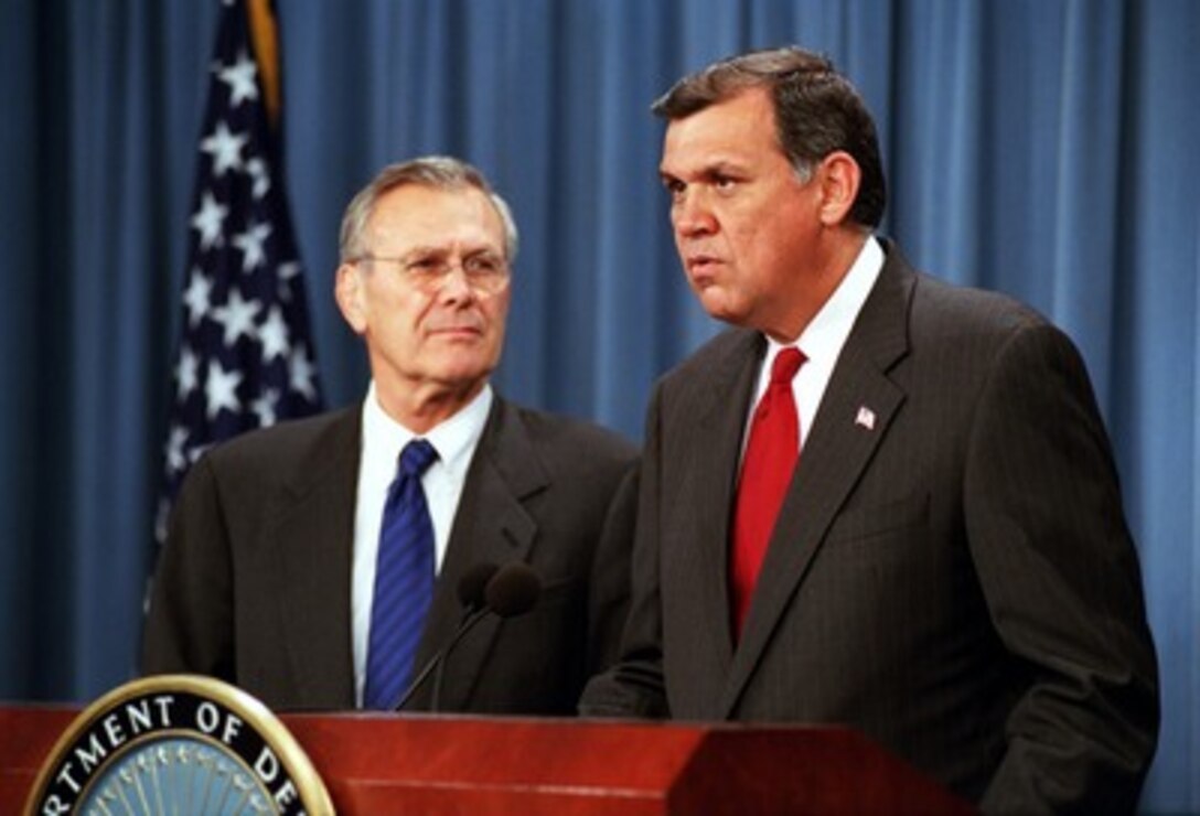 Secretary of Defense Donald H. Rumsfeld (left) shares the lectern of the Pentagon briefing room with Secretary of Housing and Urban Development Mel Martinez (right) on Sept. 24, 2001. Martinez announced several provisions enacted to assist mobilized National Guard and Reserve personnel in dealing with their mortgage and rental expenses. 