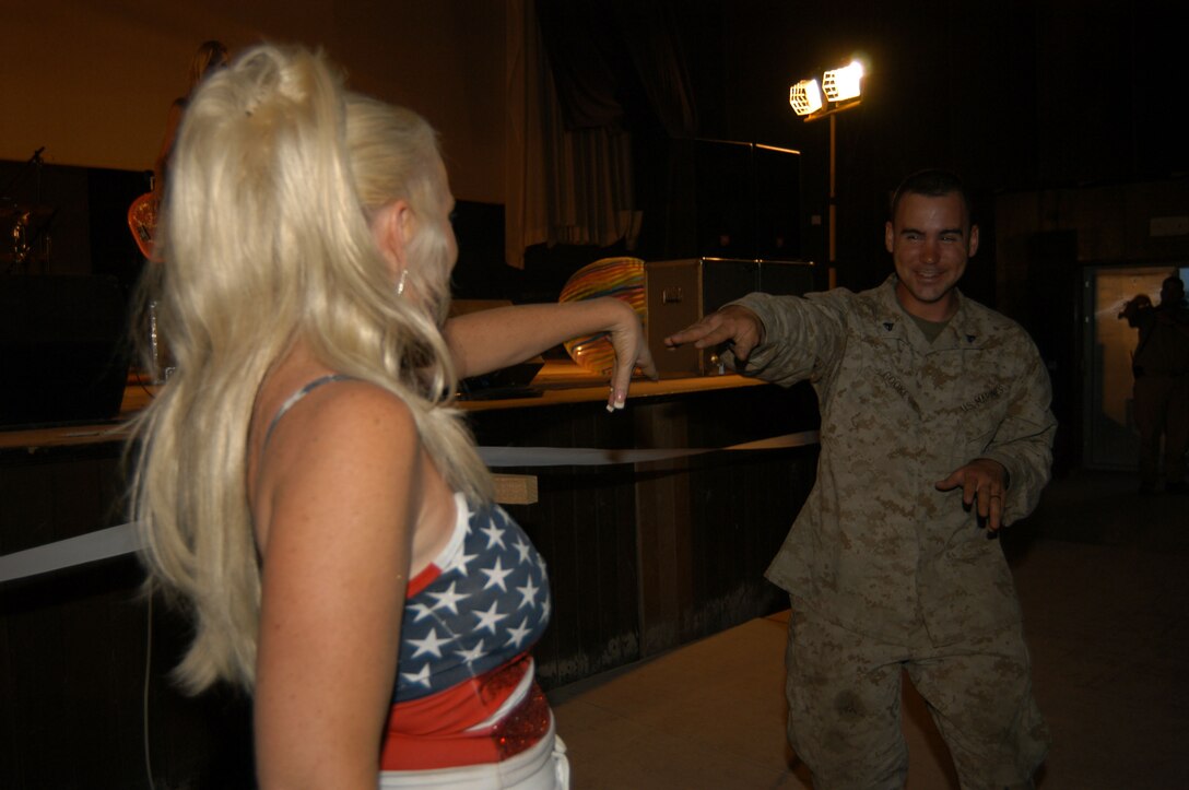 AL ASAD, Iraq--Cpl. Jerry R. Cooke, 24, of Marine Light/Attack Helicopter Squadron 269, got into the music act with Lisa Haze April 22.  Lisa is vocalist for the band The California Girls.  This performance was one stop as the band tours several locations in Iraq.  The all-female group has performed together for the past six years playing a blend of classic rock and surfer hits.