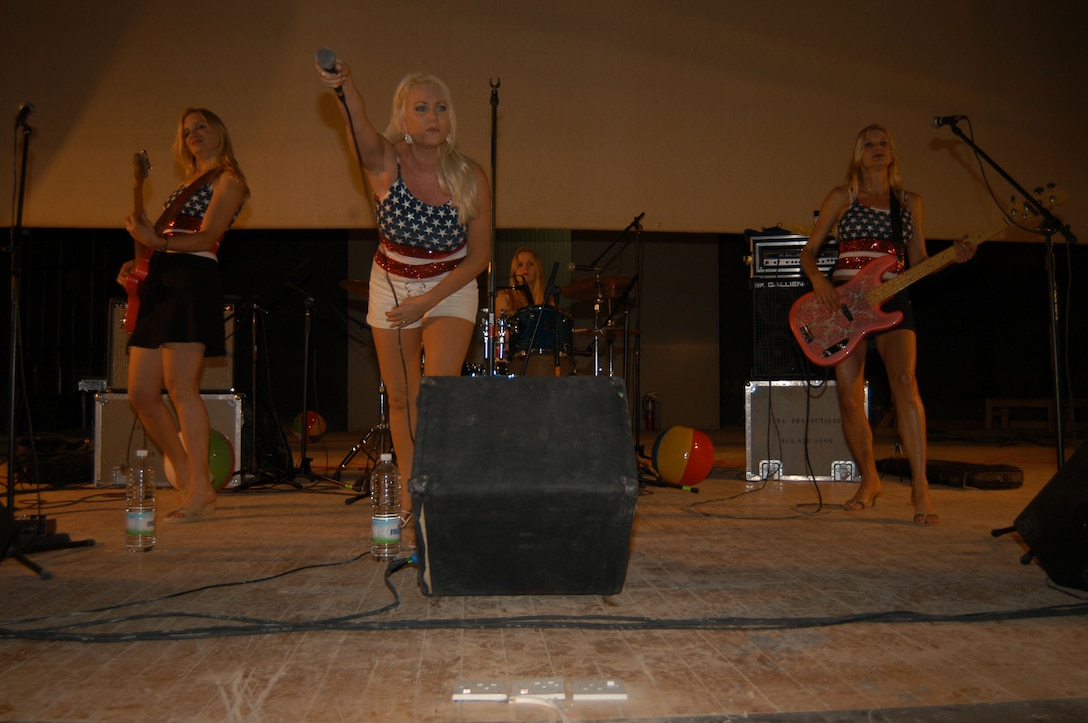 AL ASAD, Iraq--(Left to Right) Barbara Leoni, guitar, Lisa Haze, vocals, Sandra Walker, bass guitar, and Max Miller, drums, are The California Girls.  The band entertained Marines here April 22.  This performance was one stop as the band tours several locations in Iraq.  The group has performed together for the past six years playing a blend of classic rock and surfer hits.