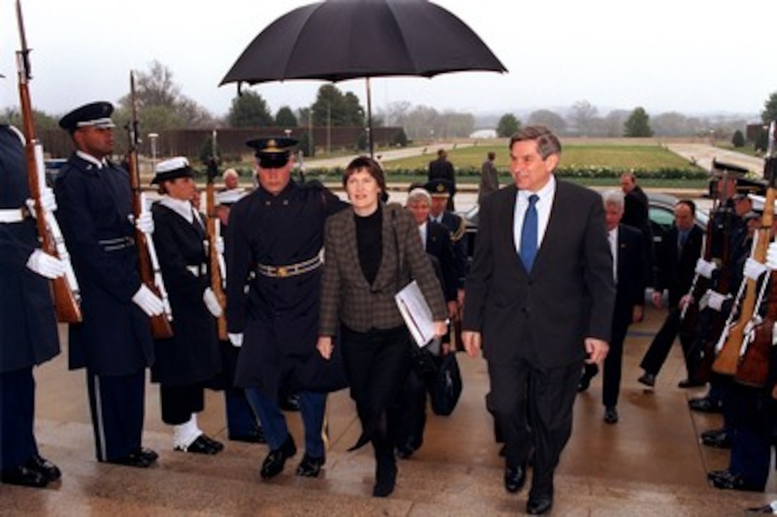Deputy Secretary of Defense Paul Wolfowitz (right) escorts New Zealand's Prime Minister Helen Clark (center) into the Pentagon on March 26, 2002. Clark and Wolfowitz will meet to discuss a broad range of bilateral security issues. 